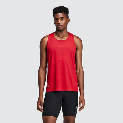A male model wearing a red sleeveless athletic tank top and black running shorts, standing against a solid light gray background.