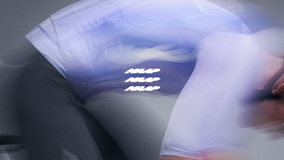 Person wearing a white shirt with text on it, sitting in a bike with a blue light effect.