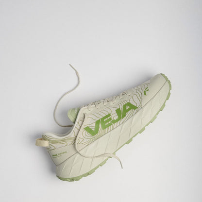 A single Veja running shoe in off-white with light green accents and laces, photographed from a high-angle perspective against a light gray background.