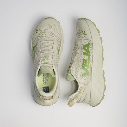 A pair of Salomon VEJA trail running shoes in a light beige and green colorway, shown from a top-down view on a light gray background. 